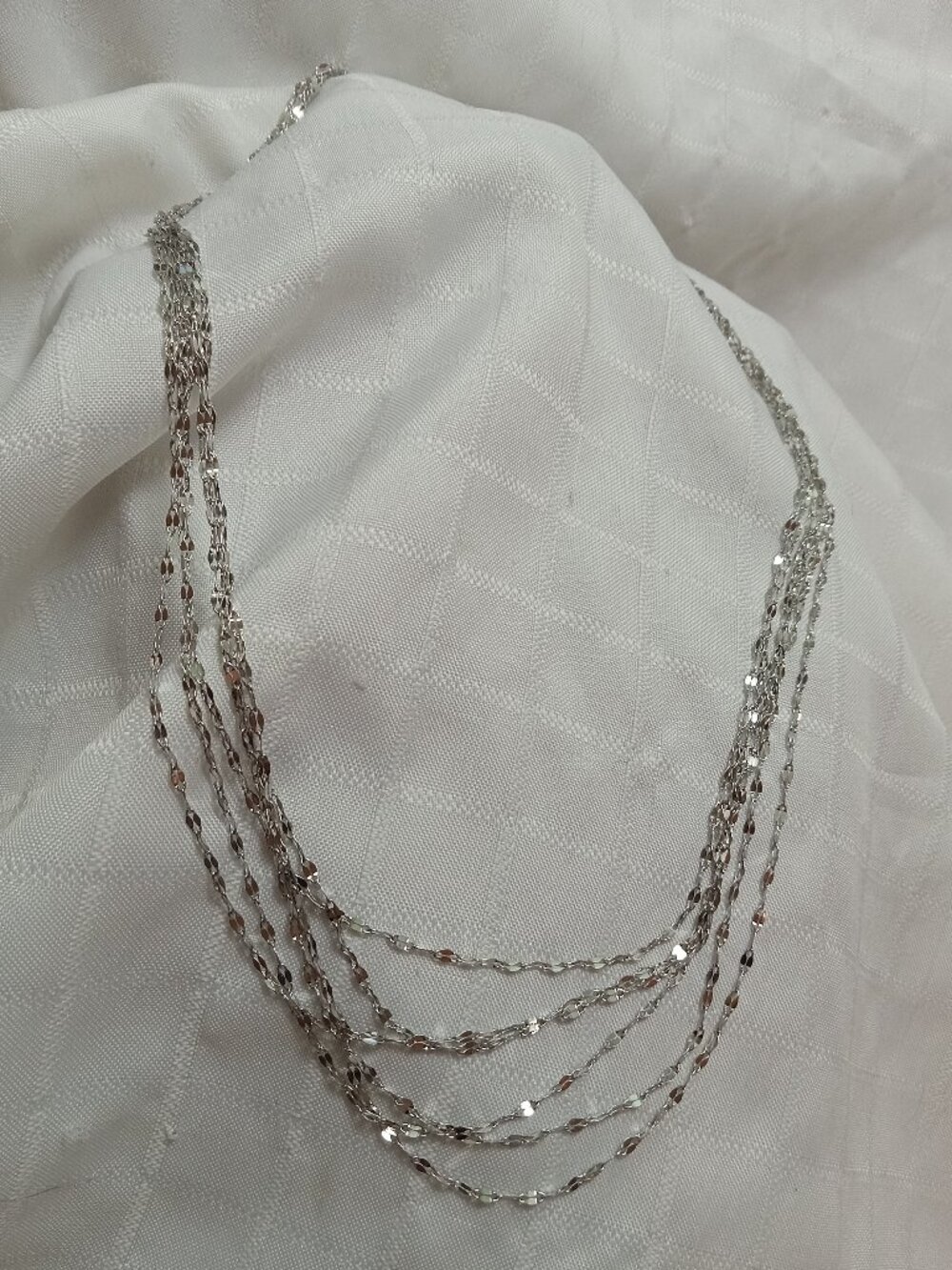 Handmade fashion nacklace with many chain rows in a silver color